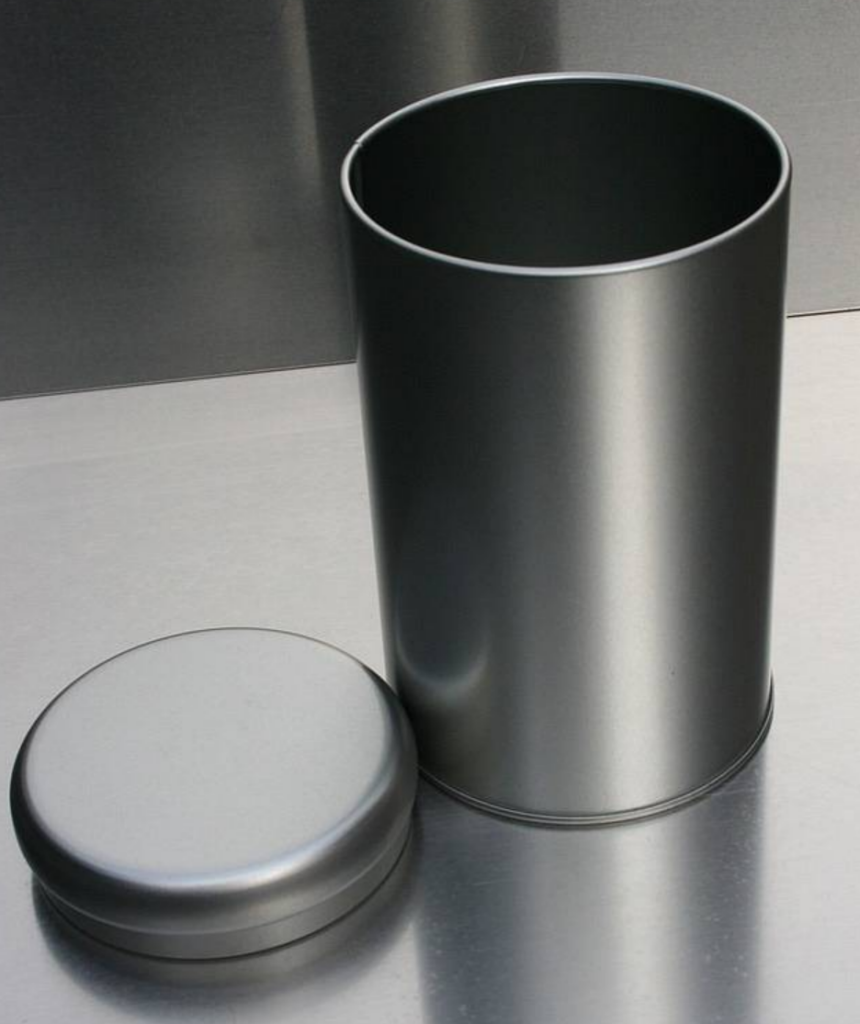 Photo of the metal trash can with the lid next to it