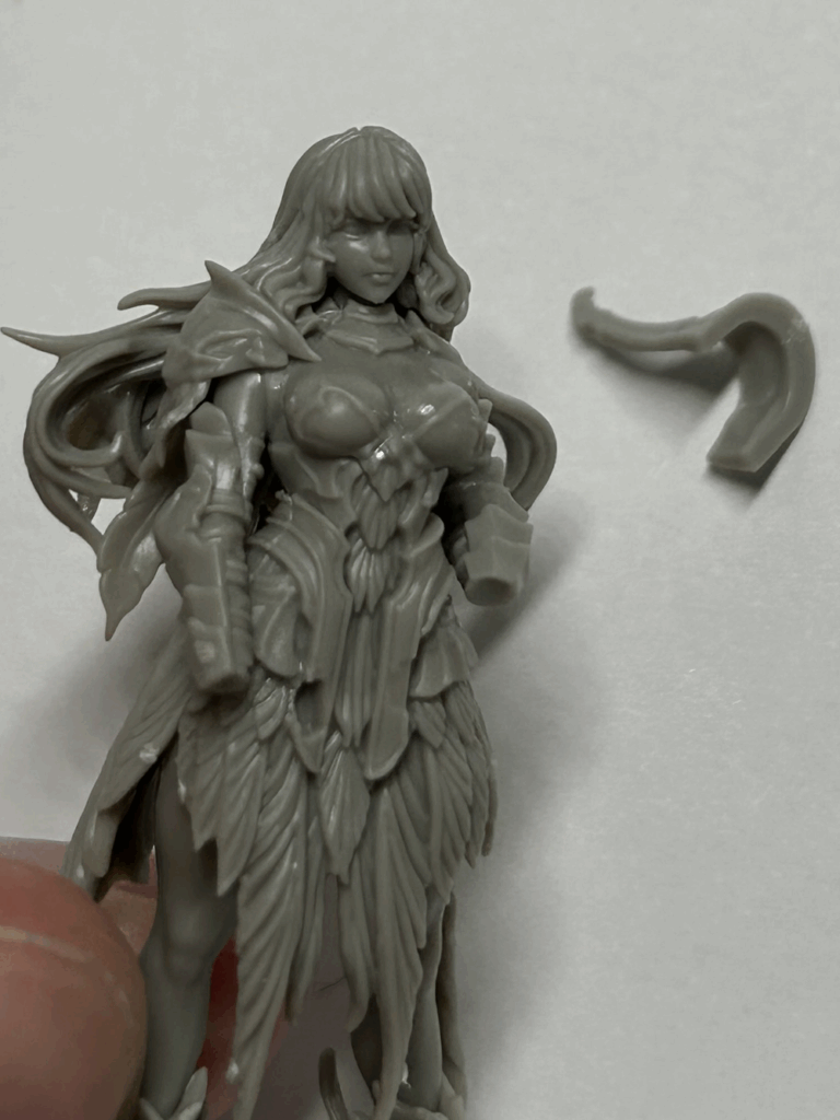 A close up of a partially assembled plastic model with some parts nearby