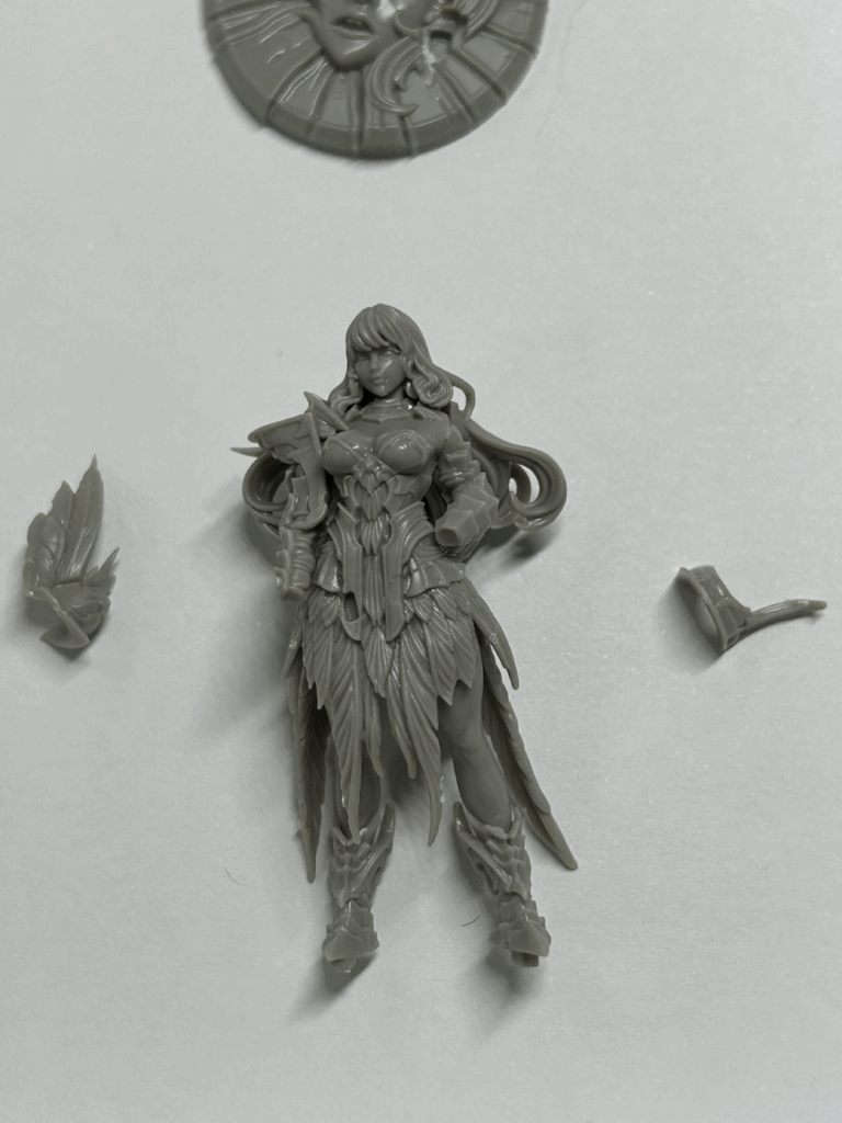 A close up of a partially assembled plastic model with some parts nearby