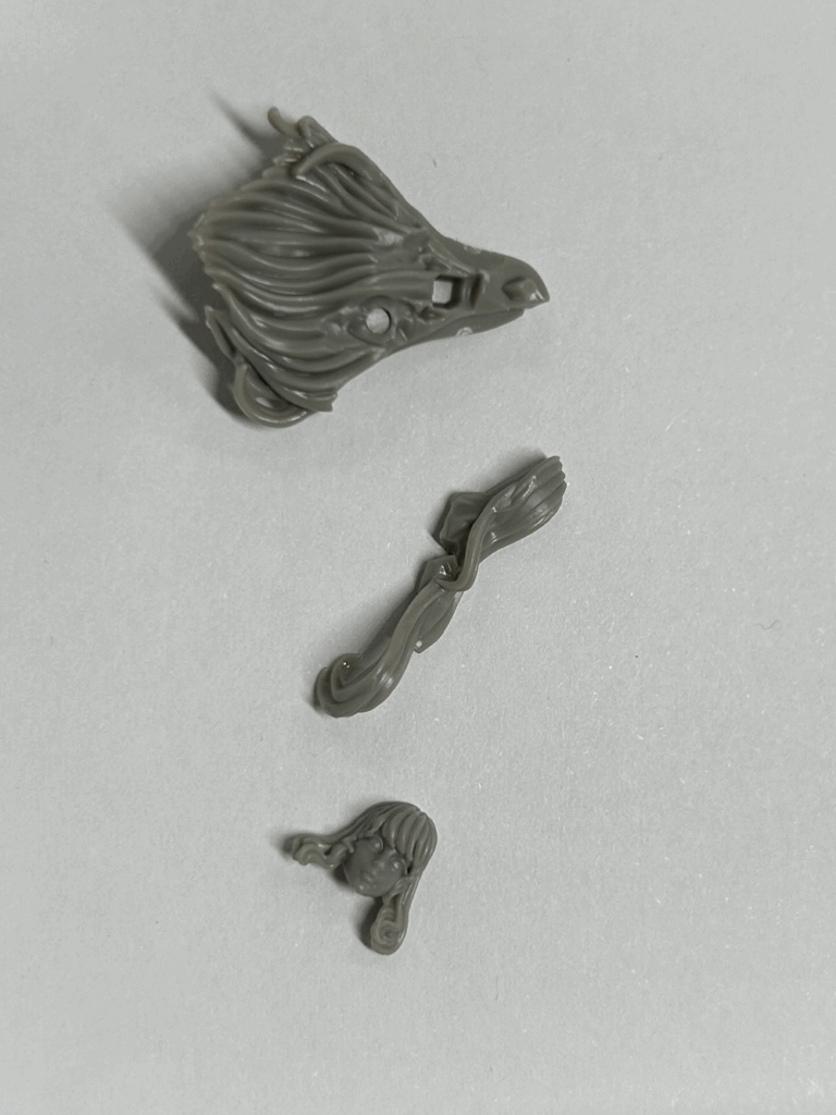 A close up of several parts of a hard plastic model.