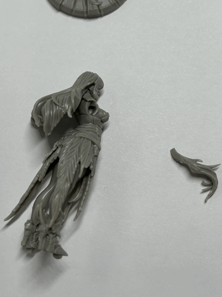 A close up of a partially assembled plastic model with some parts nearby