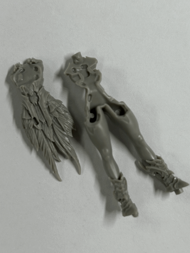 A close up of several parts of a hard plastic model.