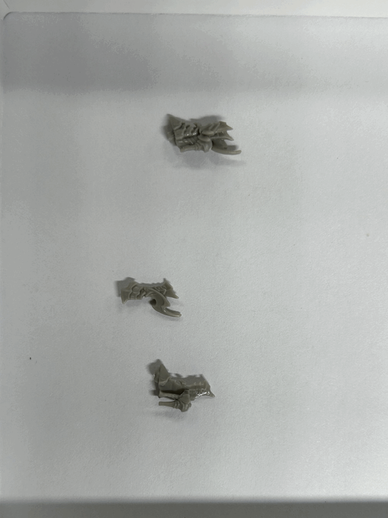 A close up of several parts of a hard plastic model.