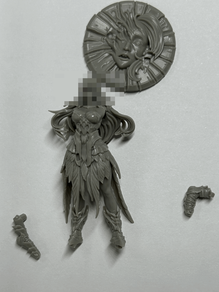 A close up of a partially assembled plastic model with some parts nearby