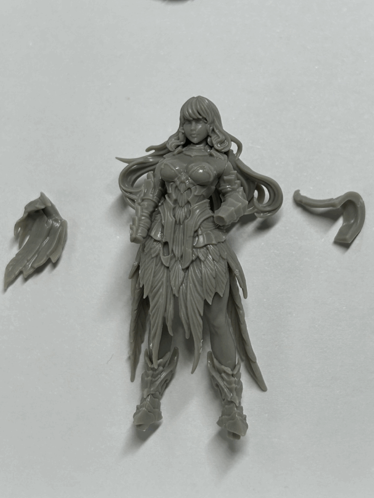 A close up of a partially assembled plastic model with some parts nearby